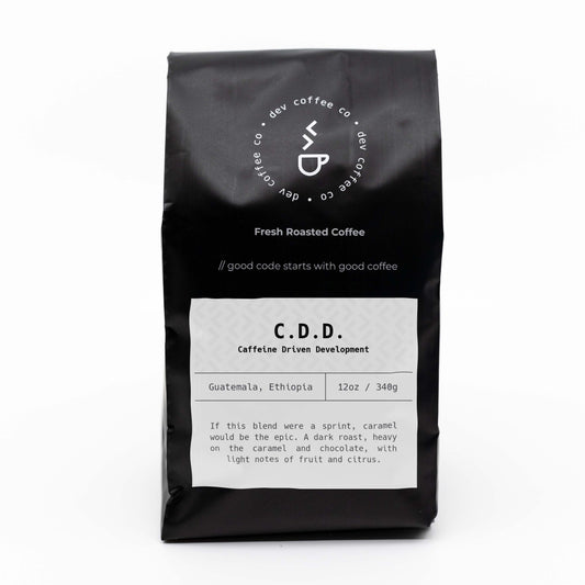Front of bag of 12oz "Caffeine Driven Development" Premium Coffee from Dev Coffee Co. Good code starts with good coffee.