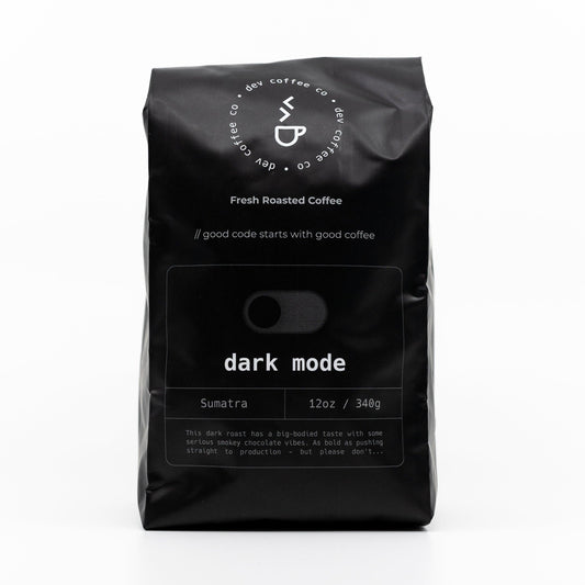 Front of bag of 12oz "Dark mode" Premium Coffee from Dev Coffee Co. Good code starts with good coffee.