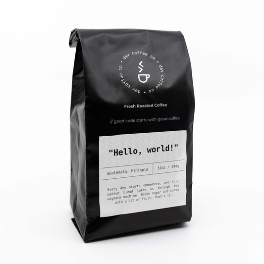 Angle of bag of 12oz "Hello, world!" Premium Coffee from Dev Coffee Co. Good code starts with good coffee.