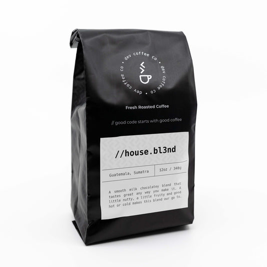 Angle of bag of 12oz House Blend Premium Coffee from Dev Coffee Co. Good code starts with good coffee.