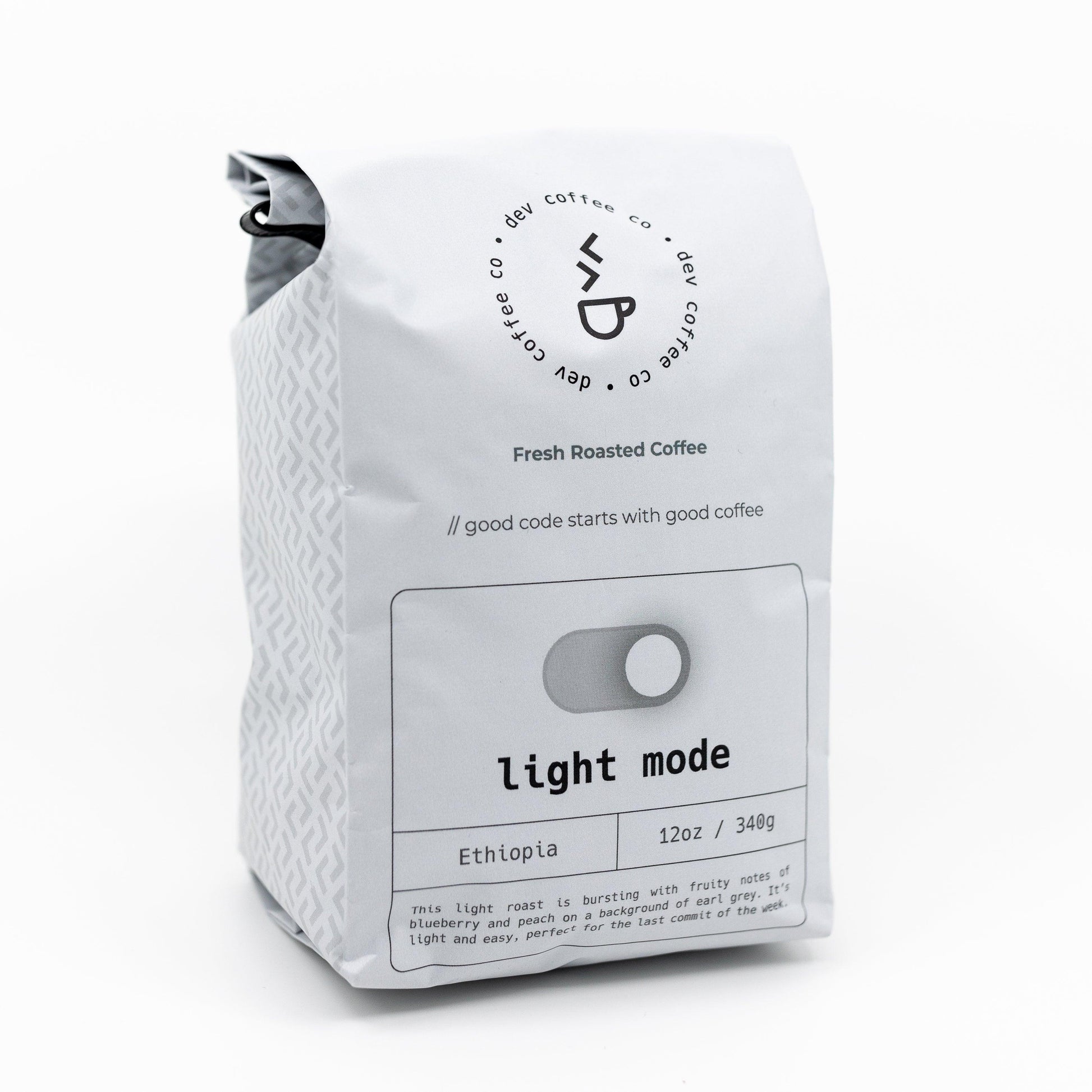 Angle of bag of 12oz "Light mode" Premium Coffee from Dev Coffee Co. Good code starts with good coffee.